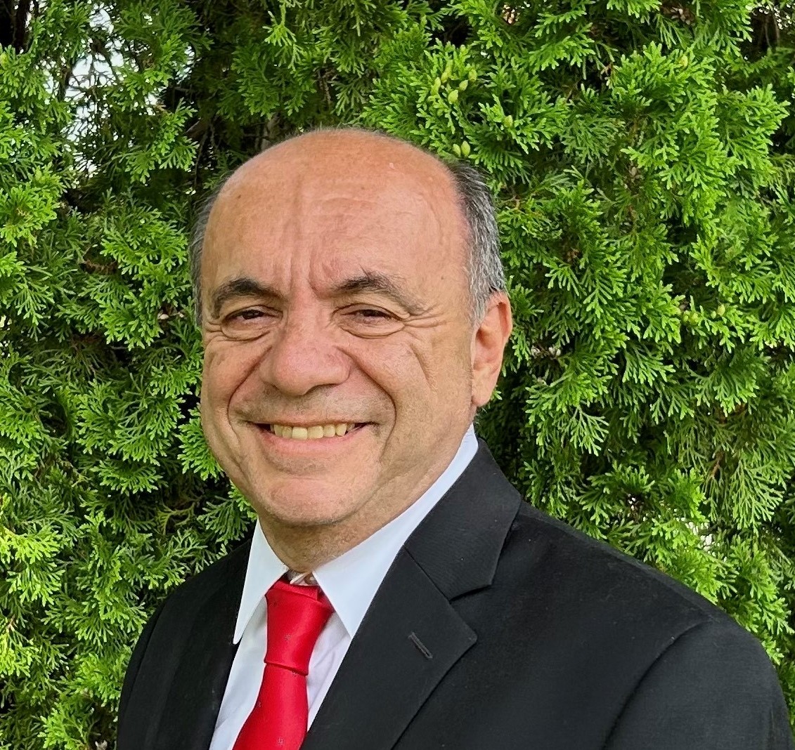 Picture of Anthony Caggiano dressed in black suit with red tie